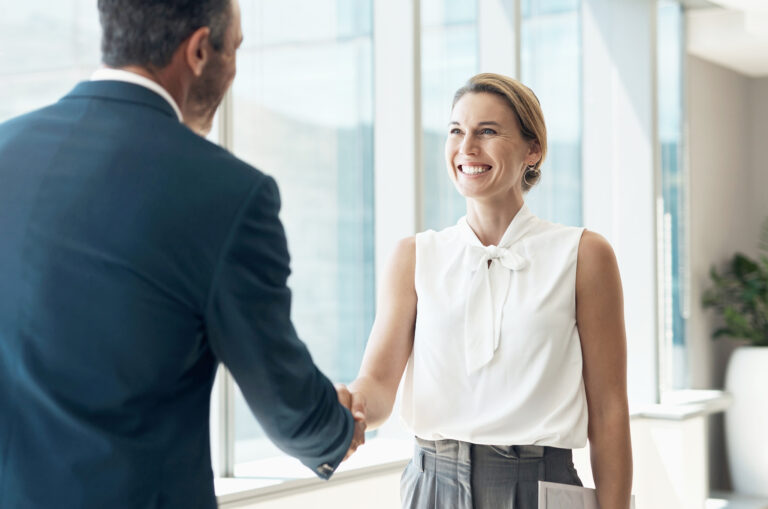 Handshake, meeting and business people partnership for b2b collaboration, onboarding welcome or professional opportunity. Corporate woman or clients shake hands for deal in office building interview